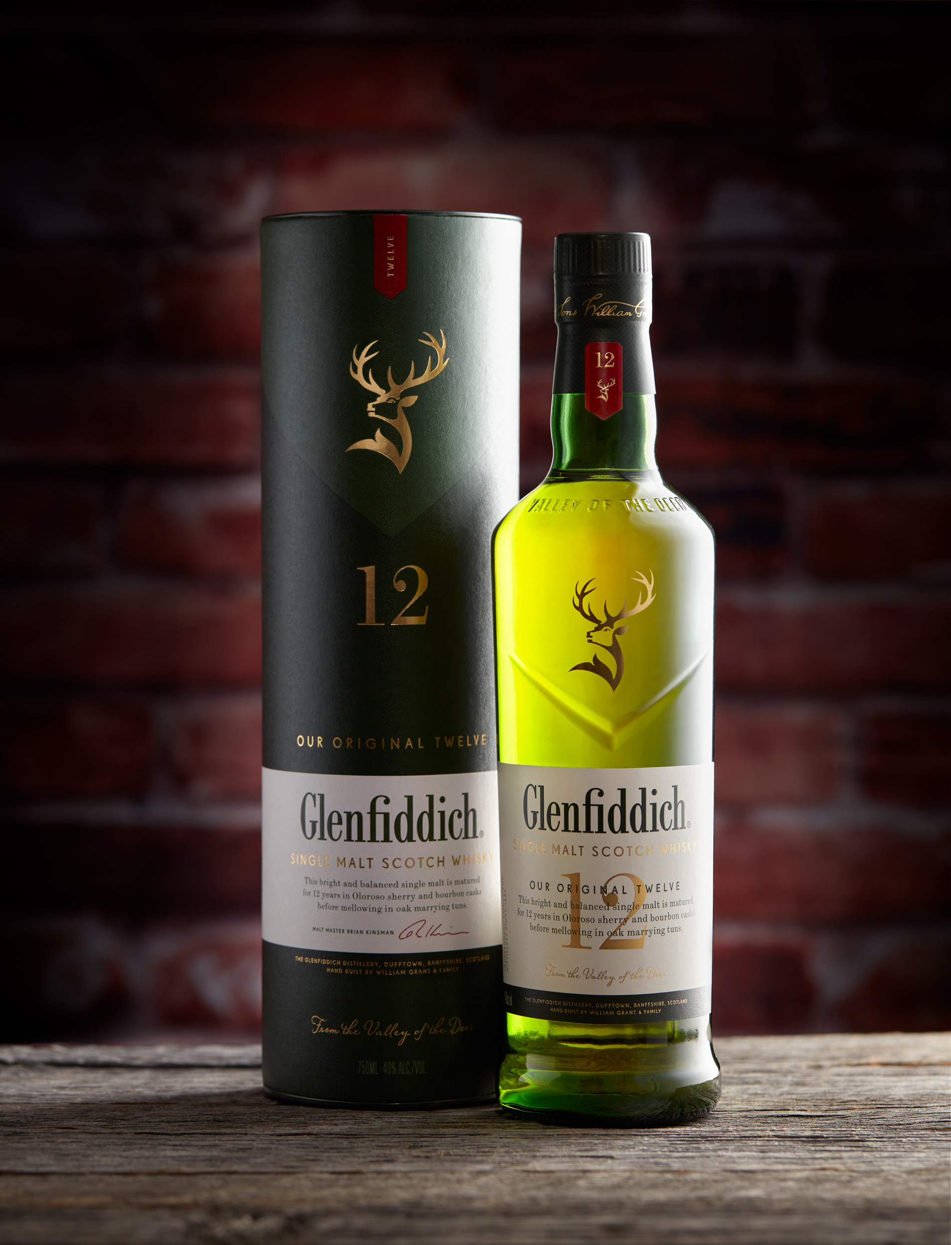 Studio product photo of a Glenfiddich Scotch Whiskey bottle and packaging.