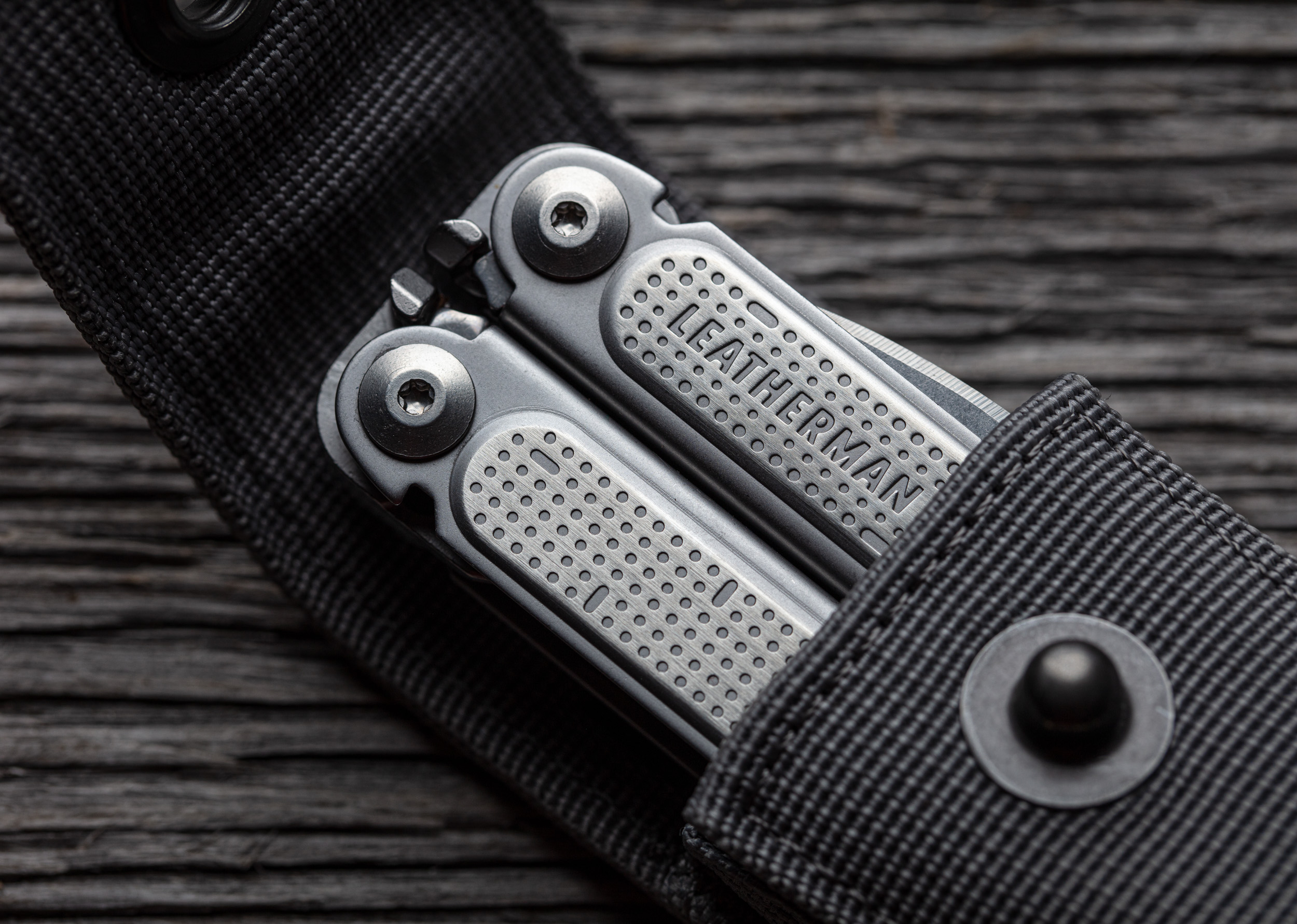 Product photograph of a Leatherman multi tool on wood background