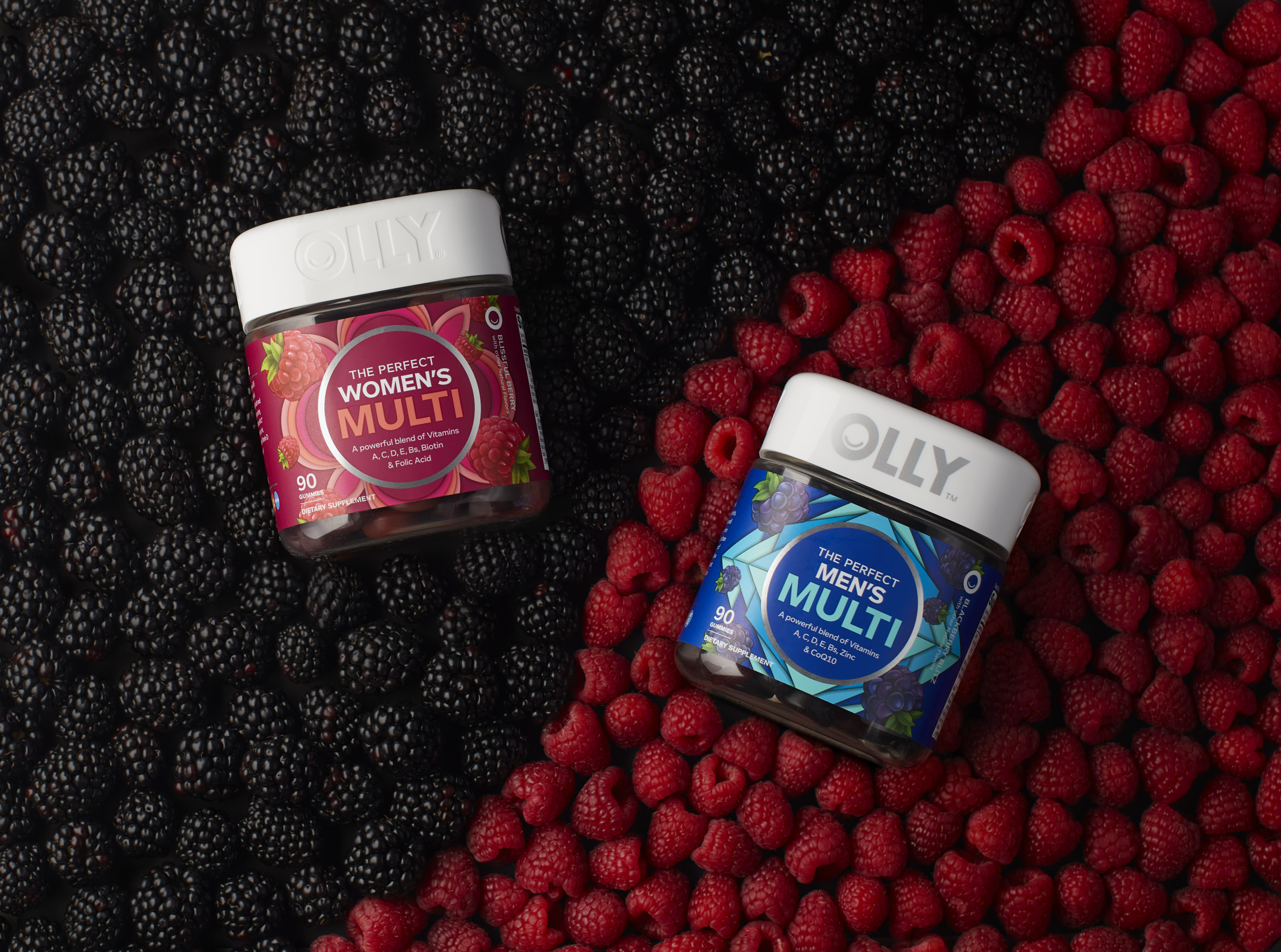 Olly Multi Vitamins on a bed of fruit in still life product photo.