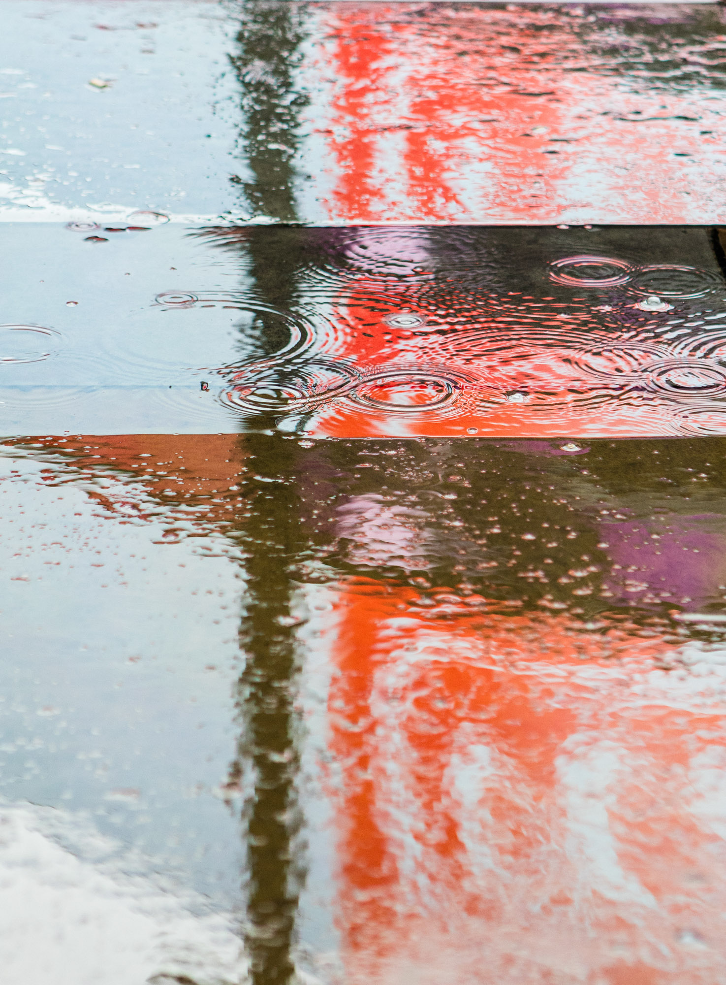 Fine Art photo of puddles reflecting lights in Leicester Square, London.