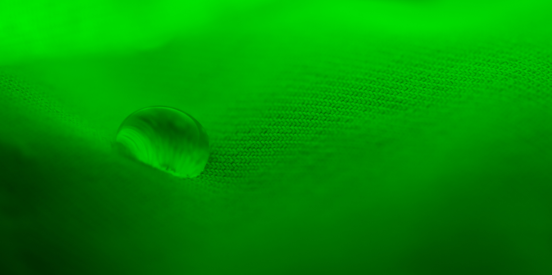 Macro Fine Art photo of a water droplet on a green textile.