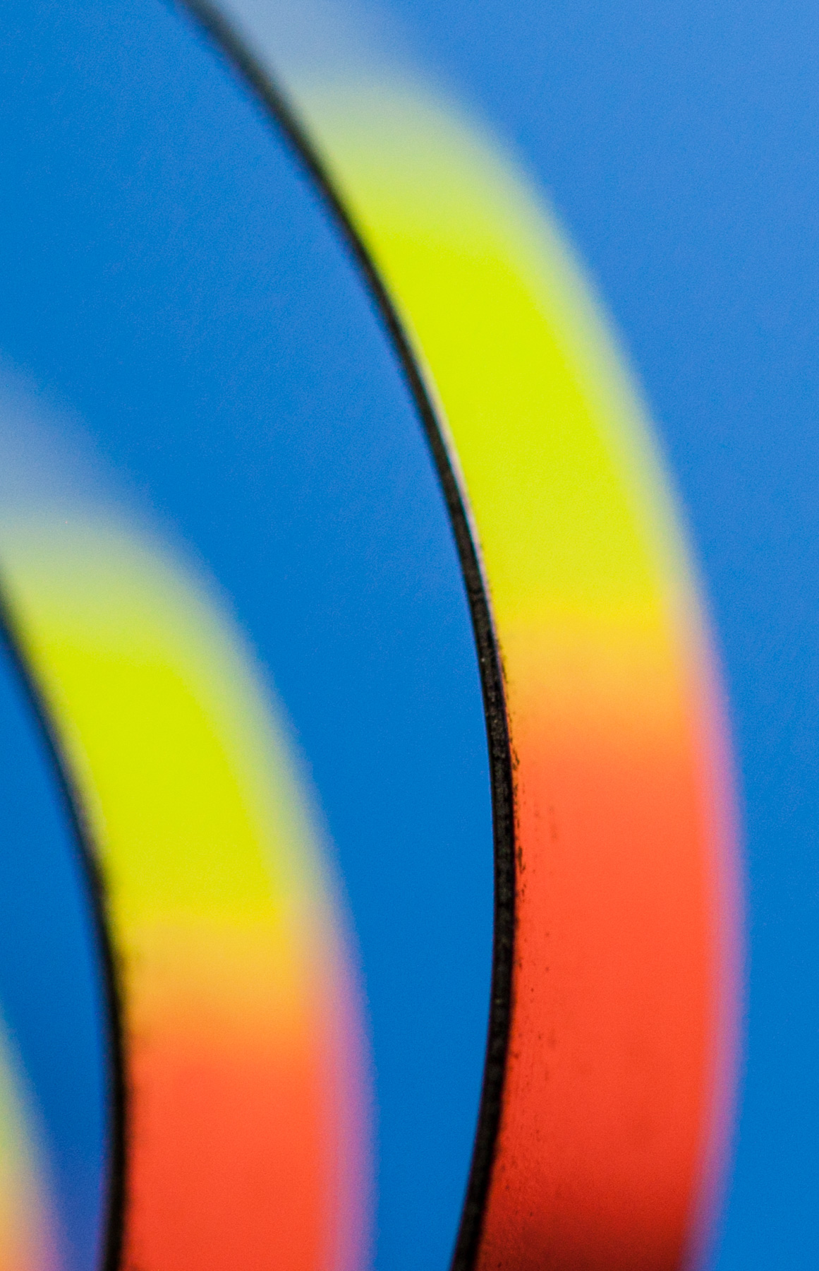 Macro Fine Art photo of color reflecting on steel bands.