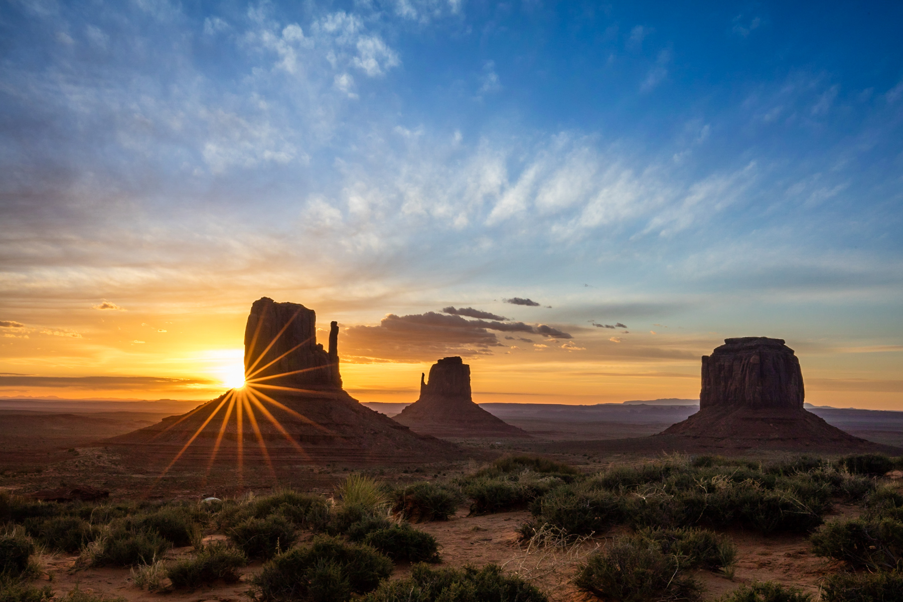 Sunrise with sunburst in Monument Valley, Utah.