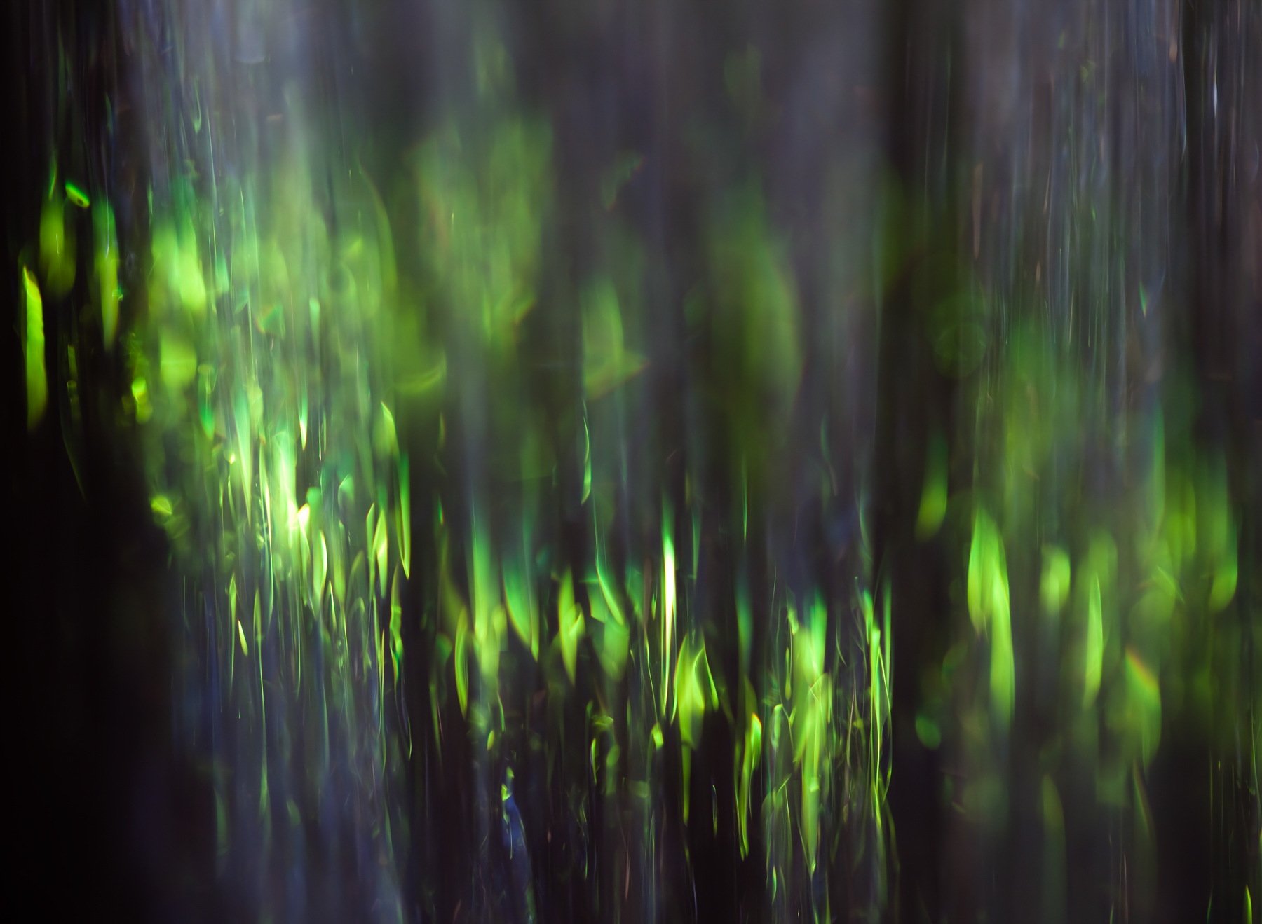 Fine Art Photo of falling water refracting green stained glass.